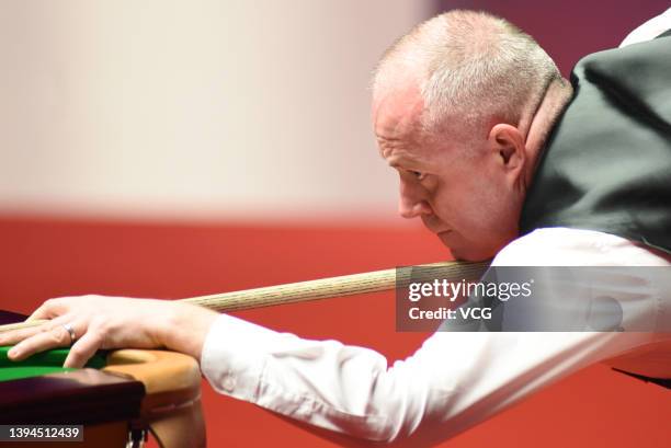 John Higgins of Scotland plays a shot during the semi-final match against Ronnie O'Sullivan of England on day 14 of the Betfred World Snooker...