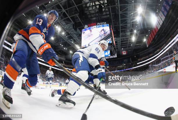 Mathew Barzal of the New York Islanders and Erik Cernak of the Tampa Bay Lightning battle for the puck during the third period at UBS Arena on April...