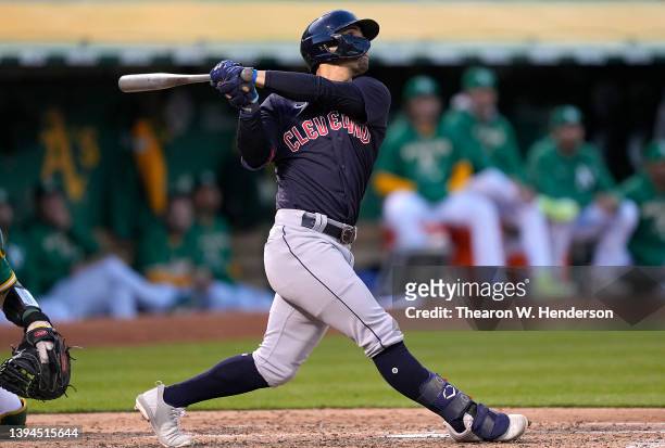 Andres Gimenez of the Cleveland Guardians hits a grand slam home run against the Oakland Athletics in the top of the third inning at RingCentral...