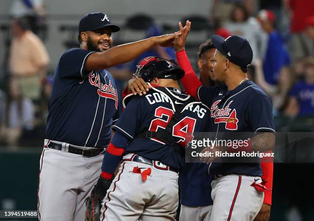 Kenley Jansen of the Atlanta Braves high fives teammate Orlando Arcia after the win over the Texas Rangers at Globe Life Field on April 29, 2022 in...