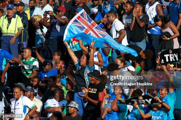 Fijian Drua fans celebrate a try during the round 11 Super Rugby Pacific match between the Fijian Drua and the Highlanders at ANZ Stadium on April...