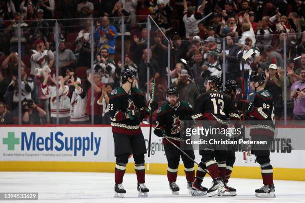 Michael Carcone of the Arizona Coyotes celebrate with Jack McBain, Nick Ritchie and J.J. Moser after scoring a goal against the Nashville Predators...