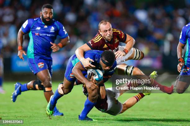 Vinaya Habosi of Fijian Drua is tackled by Hugh Renton of the Highlanders during the round 11 Super Rugby Pacific match between the Fijian Drua and...