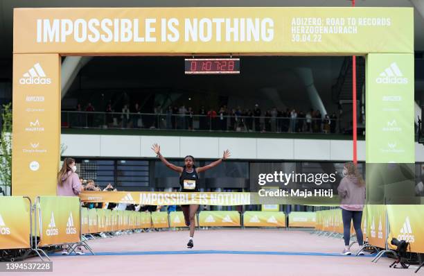 Tigist Assefa of Ethiopia celebrates as they cross the line to win the Women's 21K Race. World class road runners compete at the second annual...