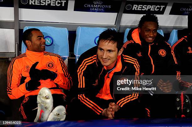 Chelsea substitutes Ashley Cole, Frank Lampard and John Obi Mikel look on from the dugout during the UEFA Champions League round of 16 first leg...