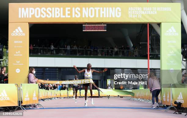 Mathew Kimeli of Kenya celebrates as they cross the line to win the Men's 21K Race. World class road runners compete at the second annual adidas’...