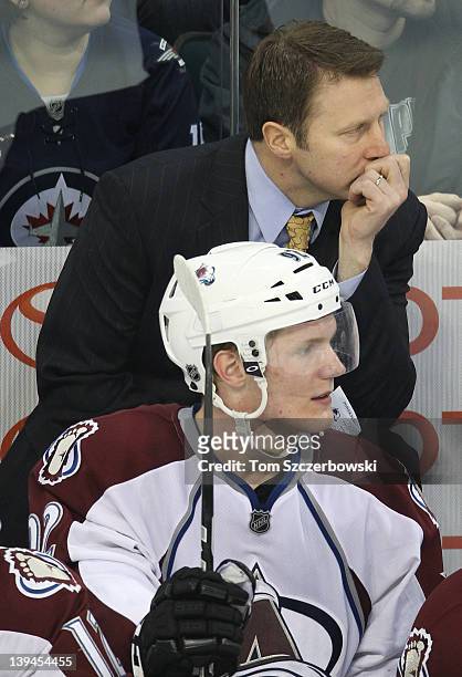 Head coach Joe Sacco of the Colorado Avalanche and Gabriel Landeskog look on from the bench during their NHL game against the Winnipeg Jets at MTS...