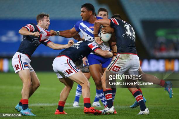 Tevita Pangai Junior of the Bulldogs is tackled during the round eight NRL match between the Canterbury Bulldogs and the Sydney Roosters at Stadium...