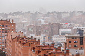 Residential buildings in Madrid under atmosphere of pollution and desertic dust