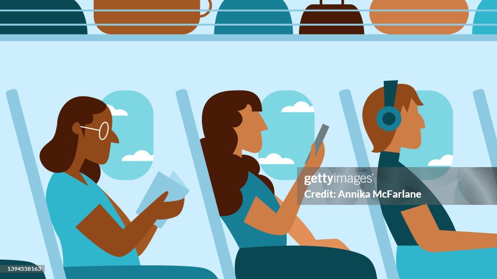 Three Multiracial Women Passengers Enjoy Airplane Flight While Reading and Using Smartphone