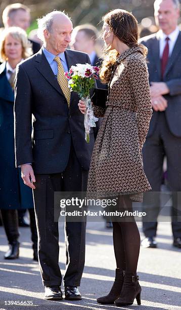 Catherine, Duchess of Cambridge holds onto her Orla Kiely dress which blows in the wind as she arrives for a visit to The Art Room's classroom at...