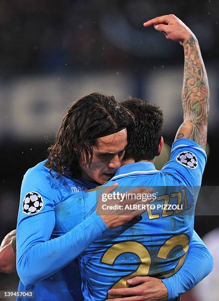 Napoli's Argentine forward Ezequiel Ivan Lavezzi is embraced by Napoli's Uruguayan forward Edinson Roberto Cavani after scoring during the Champions...