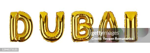 dubai word made of foil balloons isolated on white background - helium luftballons stock-fotos und bilder