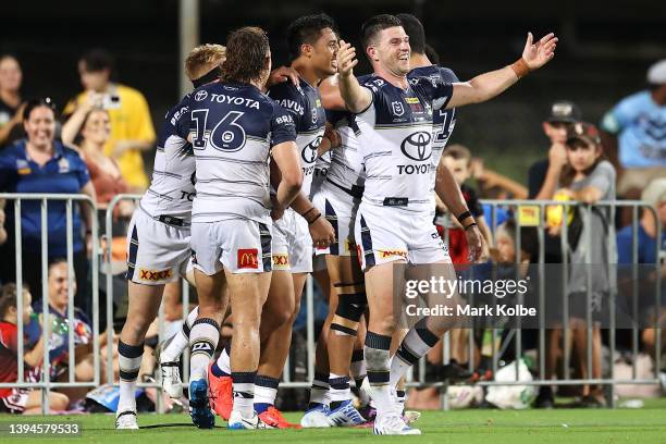 Chad Townsend of the Cowboys and his team mates celebrate with Hamiso Tabuai-Fidow of the Cowboys after he scored a try during the round eight NRL...