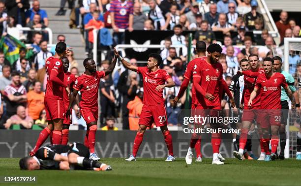 Naby Keita celebrates with teammate Luis Diaz of Liverpool after scoring their team's first goal during the Premier League match between Newcastle...