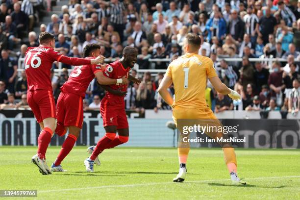 Naby Keita celebrates with teammates Luis Diaz and Andrew Robertson of Liverpool after scoring their team's first goal during the Premier League...