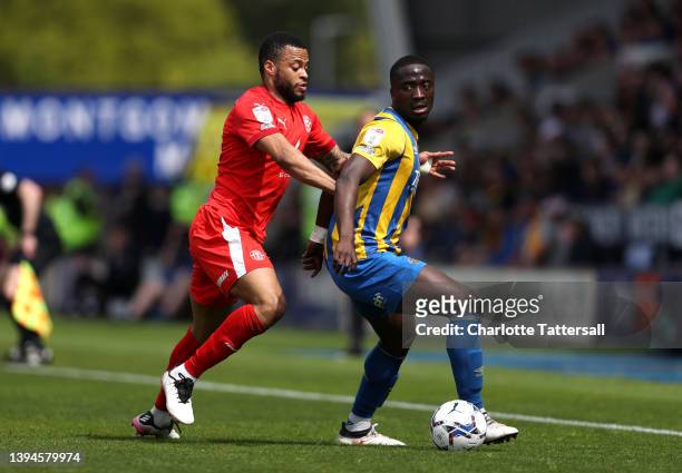Jordan Cousins of Wigan Athletic challenges Daniel Udoh of Shrewsbury Town during the Sky Bet League One match between Shrewsbury Town and Wigan...