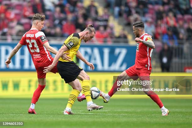 Bradley Fink of Borussia Dortmund II is tackled by Philipp Hercher of 1.FC Kaiserslautern and Mike Wunderlich of 1.FC Kaiserslautern during the 3....