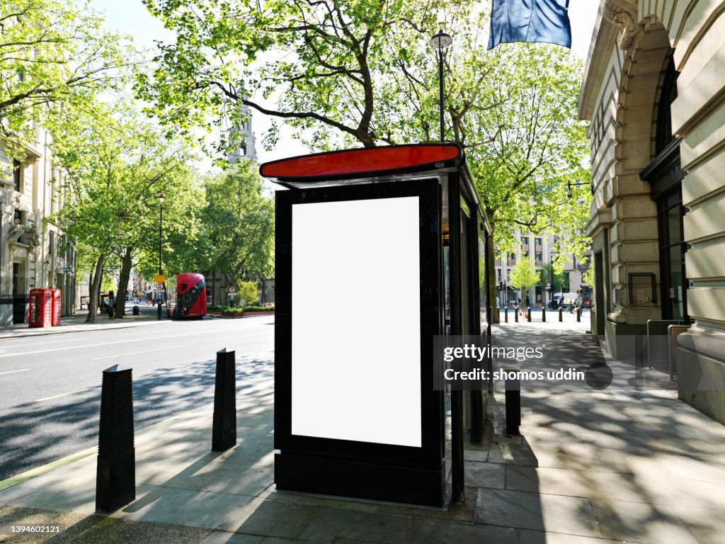 Street of London with blank digital billboard at a bus stop