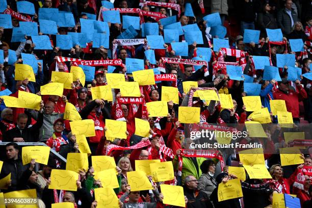 Fans of 1.FSV Mainz 05 display signs to indicate peace and sympathy with Ukraine prior to the Bundesliga match between 1. FSV Mainz 05 and FC Bayern...