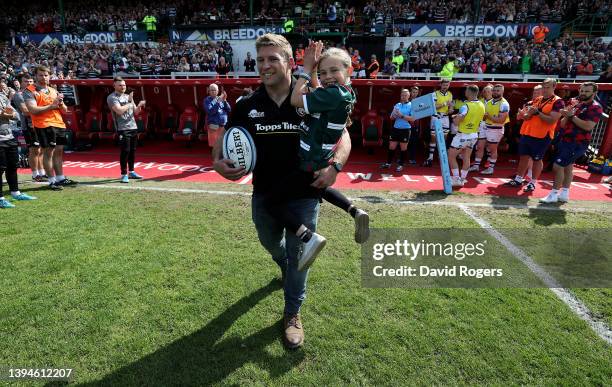 Leicester Tigers former captain, Tom Youngs carries his daughter Maisie as he leads out the team after announcing his retirement from rugby during...