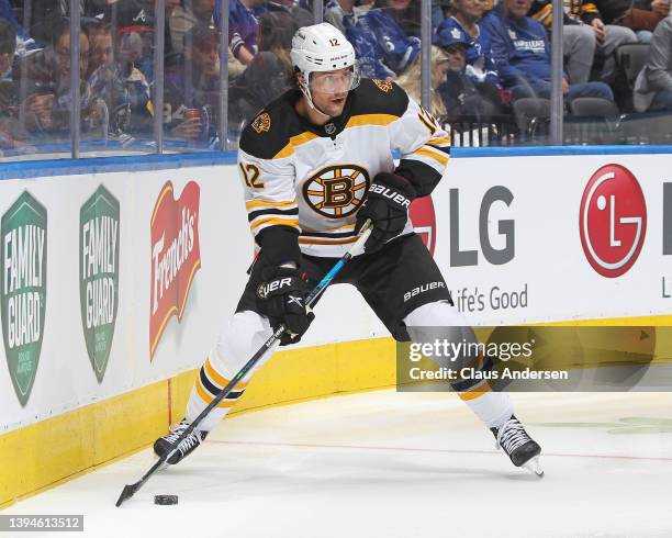 Craig Smith of the Boston Bruins skates with the puck against the Toronto Maple Leafs during an NHL game at Scotiabank Arena on April 29, 2022 in...