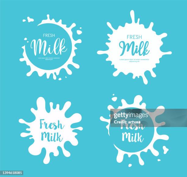 milk labels. yogurt or cream splashes - milk splashing stock illustrations