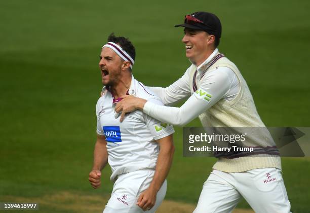 Jack Brooks of Somerset celebrates after taking the wicket of Michael Burgess of Warwickshire with team mate Tom Banton during Day Three of the LV=...
