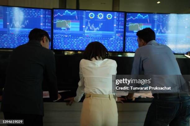 young businessman team traders analyzing computer data . - economist stock pictures, royalty-free photos & images