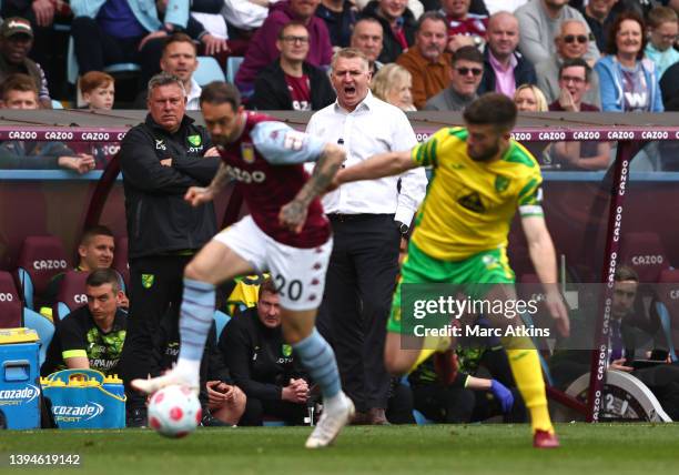 Dean Smith, Manager of Norwich City looks on as Danny Ings of Aston Villa and Grant Hanley of Norwich City compete for the ball during the Premier...