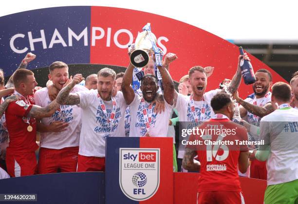 Gavin Massey of Wigan Athletic lifts the League One trophy after their sides victory during the Sky Bet League One match between Shrewsbury Town and...