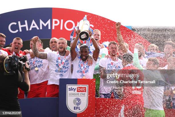 Gavin Massey of Wigan Athletic lifts the League One trophy after their sides victory during the Sky Bet League One match between Shrewsbury Town and...