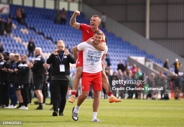 Max Power and Charlie Wyke of Wigan Athletic celebrate after their sides victory and promotion to the Championsh during the Sky Bet League One match...