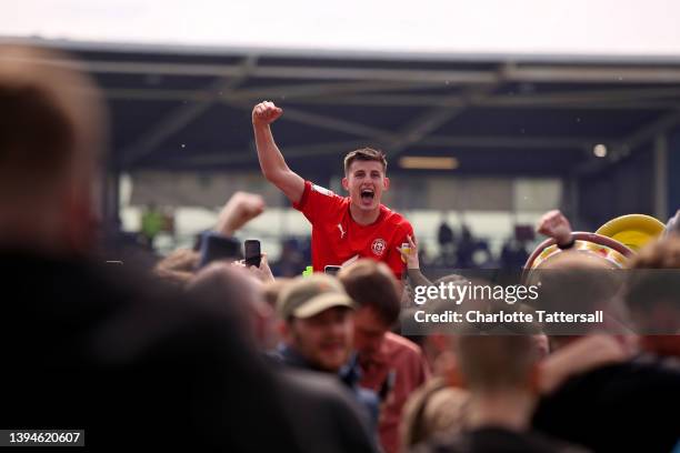 Kelland Watts of Wigan Athletic celebrates with the fans after their sides victory and promotion to the Championship during the Sky Bet League One...