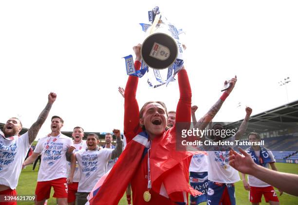 Thelo Aasgaard of Wigan Athletic celebrates with the League One trophy after their sides victory and promotion to the Championship during the Sky Bet...