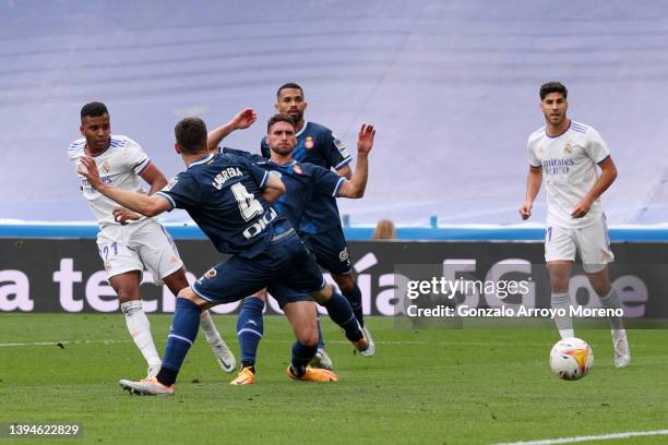 Rodrygo of Real Madrid scores their team's first goal past Leandro Cabrera of Espanyol during the LaLiga Santander match between Real Madrid CF and...