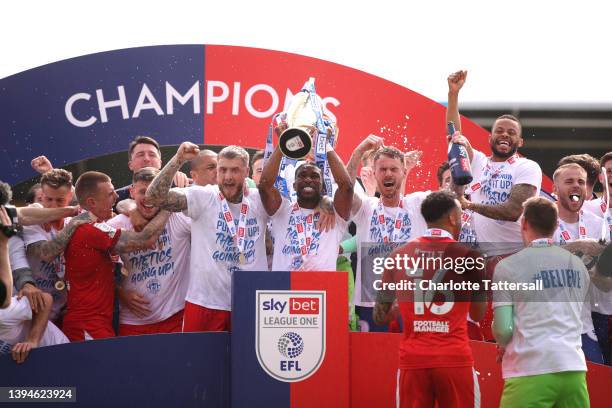 Gavin Massey of Wigan Athletic lifts the League One trophy after their sides victory during the Sky Bet League One match between Shrewsbury Town and...