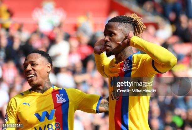 Wilfried Zaha of Crystal Palace celebrates with teammate Nathaniel Clyne after scoring their team's second goal during the Premier League match...