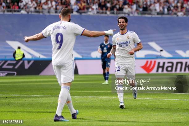 Isco of Real Madrid celebrates with teammate Karim Benzema after scoring their team's third goal during the LaLiga Santander match between Real...