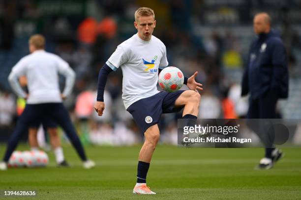 Oleksandr Zinchenko of Manchester City warms up wearing a t-shirt to indicate peace and sympathy with Ukraine prior to the Premier League match...