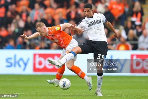 Shayne Lavery of Blackpool battles for possession with Curtis Davies of Derby County during the Sky Bet Championship match between Blackpool and...