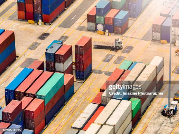 aerial view, containers ship in a warehouse in evening for import and export business, logistics. - shipyard aerial stock pictures, royalty-free photos & images