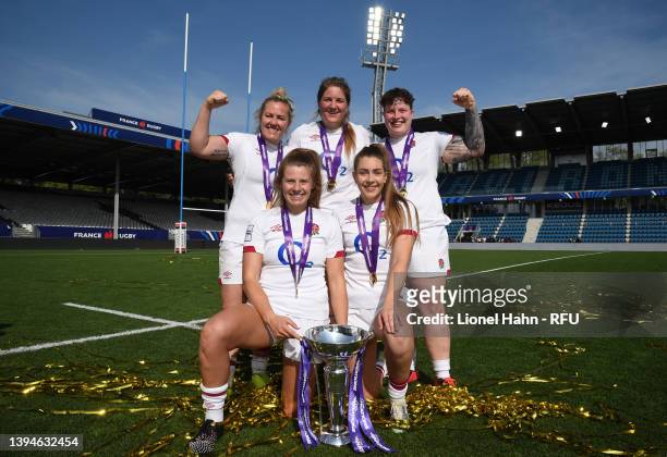 Marlie Packer, Poppy Cleall, Hannah Botterman, Zoe Harrison and Holly Aitchison of England pose with the trophy after winning the grand slam...