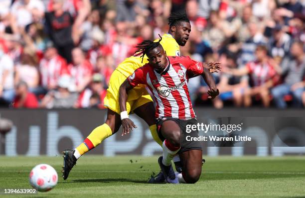 Mohammed Salisu of Southampton is tackled by Jeffrey Schlupp of Crystal Palace controls the ball during the Premier League match between Southampton...