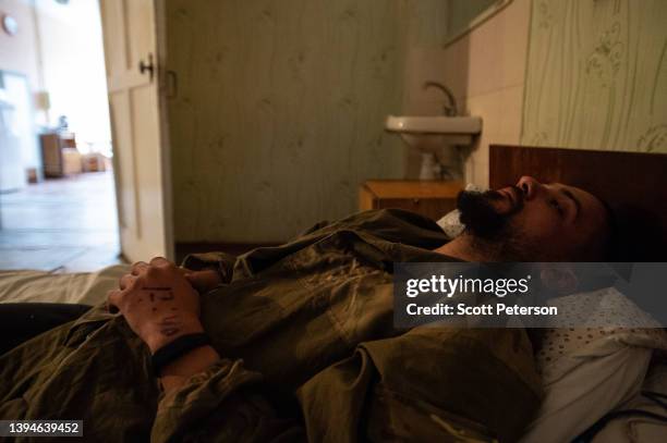 Ukrainian Territorial Defense volunteer called Serhei has the time he was administered painkillers written on his hand, as he is treated for shrapnel...