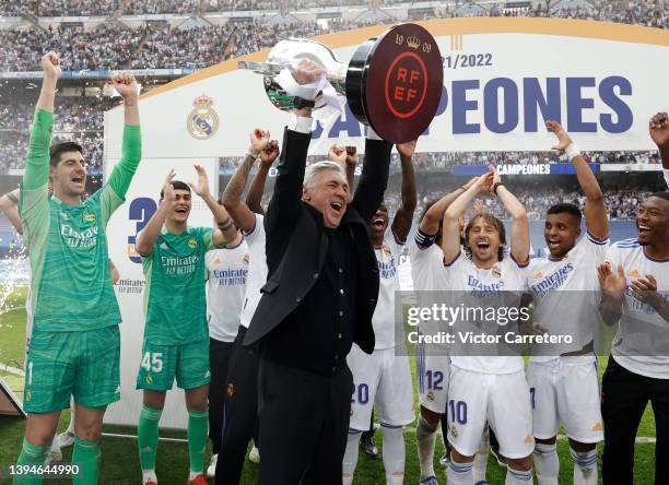 Carlo Ancelotti coach of Real MAdrid holdin the winning trophy at stadium Santiago Bernabeu on April 30, 2022 in Madrid, Spain.