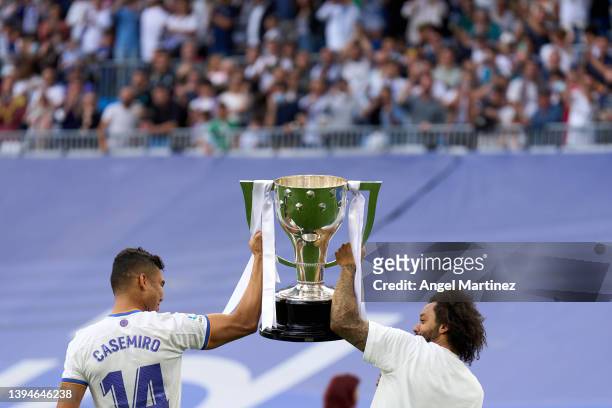 Marcelo and Casemiro of Real Madrid celebrate with the trophy after the LaLiga Santander match between Real Madrid CF and RCD Espanyol at Estadio...