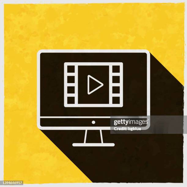watch video on desktop computer. icon with long shadow on textured yellow background - white play button stock illustrations