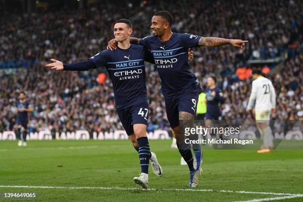 Gabriel Jesus of Manchester City celebrates with team mate Phil Foden after scoring their sides third goal during the Premier League match between...