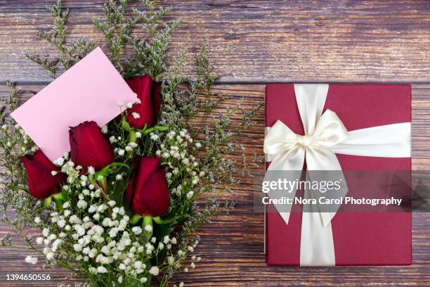 red roses bouquet with blank greeting card and gift box - maroon roses stock pictures, royalty-free photos & images